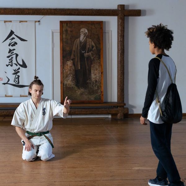 Friendly instructor guiding a new student in a calm studio.