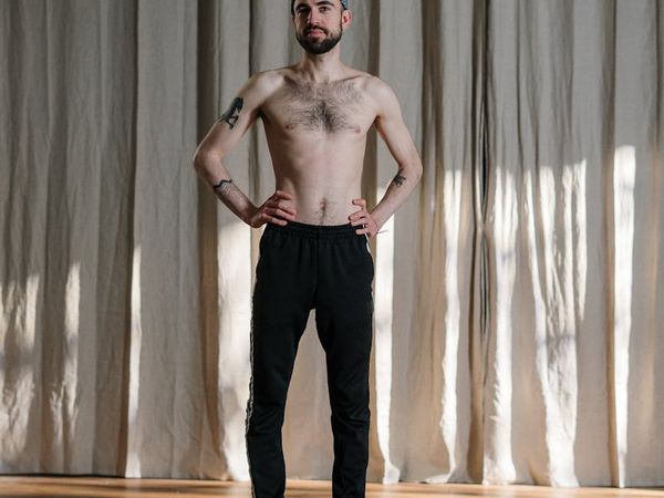 Man demonstrating core strength and flexibility on a mat.
